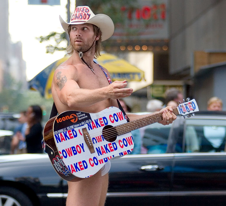 Men wear cats on their heads, and a naked cowboy plays the guitar on Times Square...